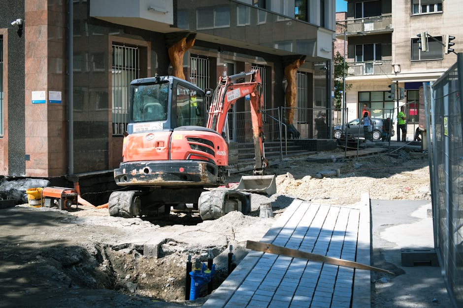 Adelaide landscaping crew working on multi-phase backyard build with paving and retaining walls in progress